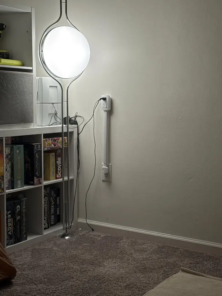 Socketify riser next to shelves and floor lamp